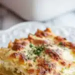 Delicious gluten-free garlic chicken lasagna plated with fresh herbs