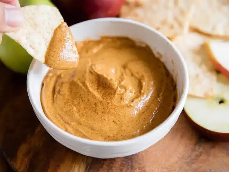 Delicious dairy-free pumpkin pie dip served in a bowl with spices and cookies.