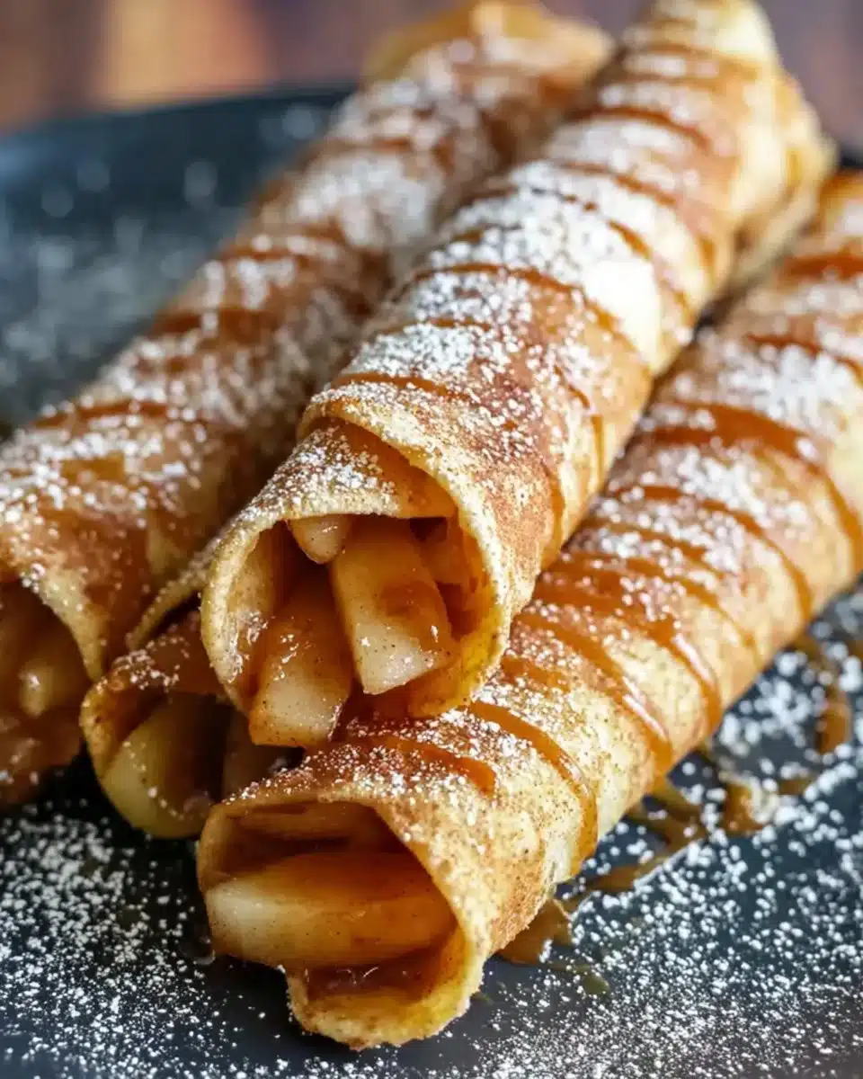 Delicious homemade Apple Taquitos garnished with cinnamon and sugar.