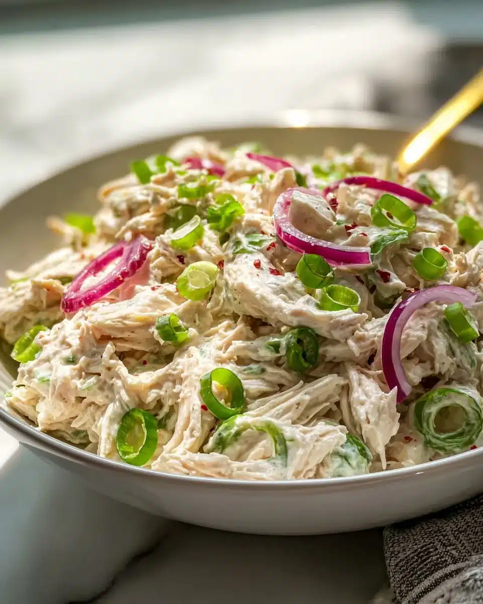Delicious chicken salad with fresh vegetables and herbs served on a plate.