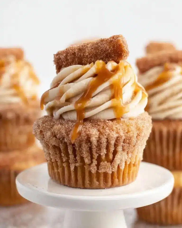 Delicious churro cupcakes topped with cinnamon sugar and frosting