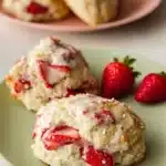 Freshly baked classic strawberry vanilla bean scones on a cooling rack.