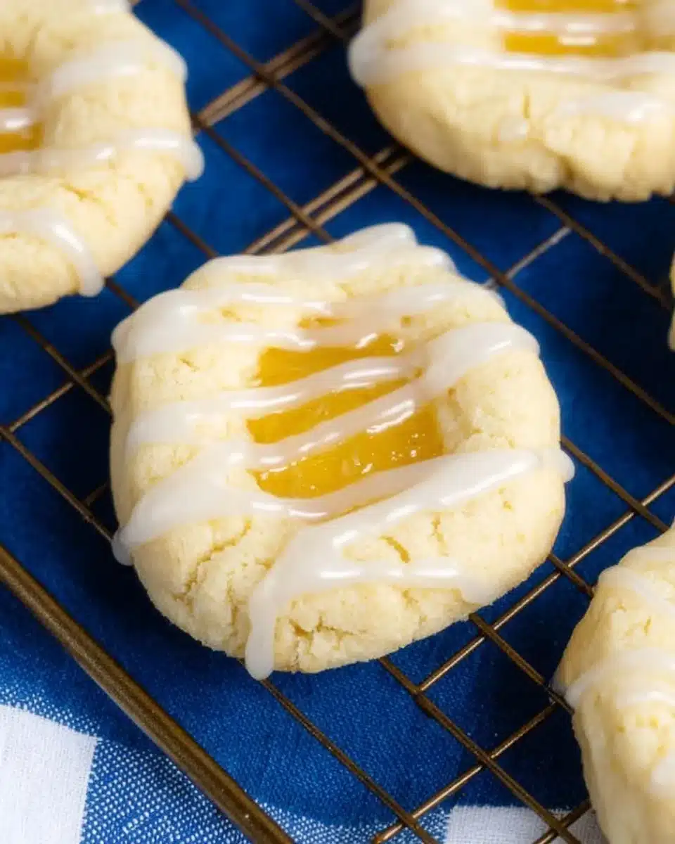 Lemon curd shortbread cookies topped with a drizzle of lemon glaze.
