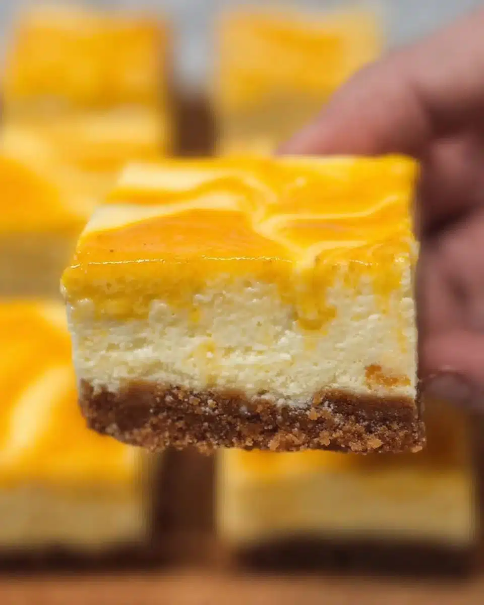 Delicious mango cheesecake bars topped with fresh mango slices
