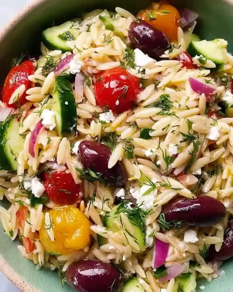 Mediterranean orzo pasta salad with fresh vegetables and herbs