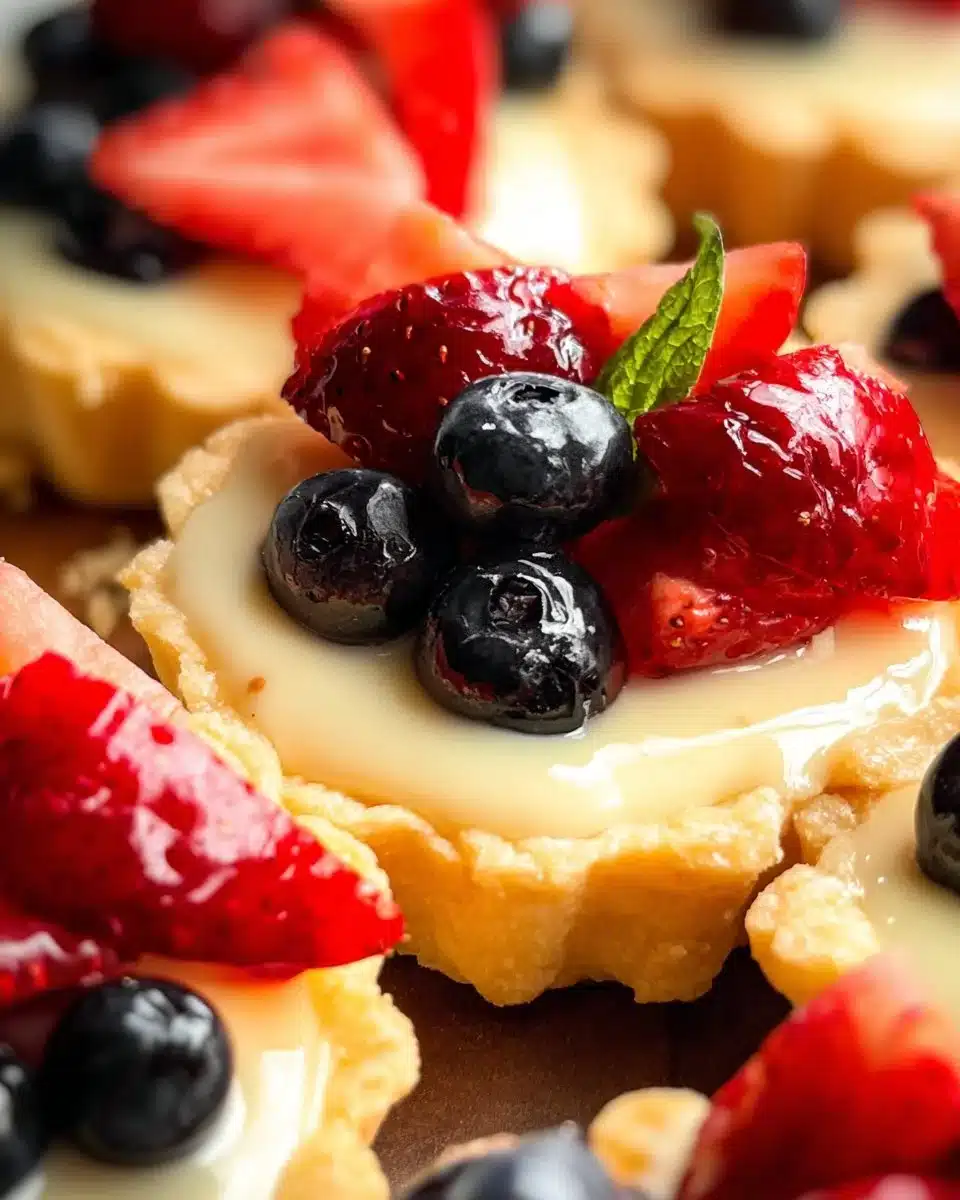 Mini sugar cookie fruit tarts topped with colorful fresh fruit