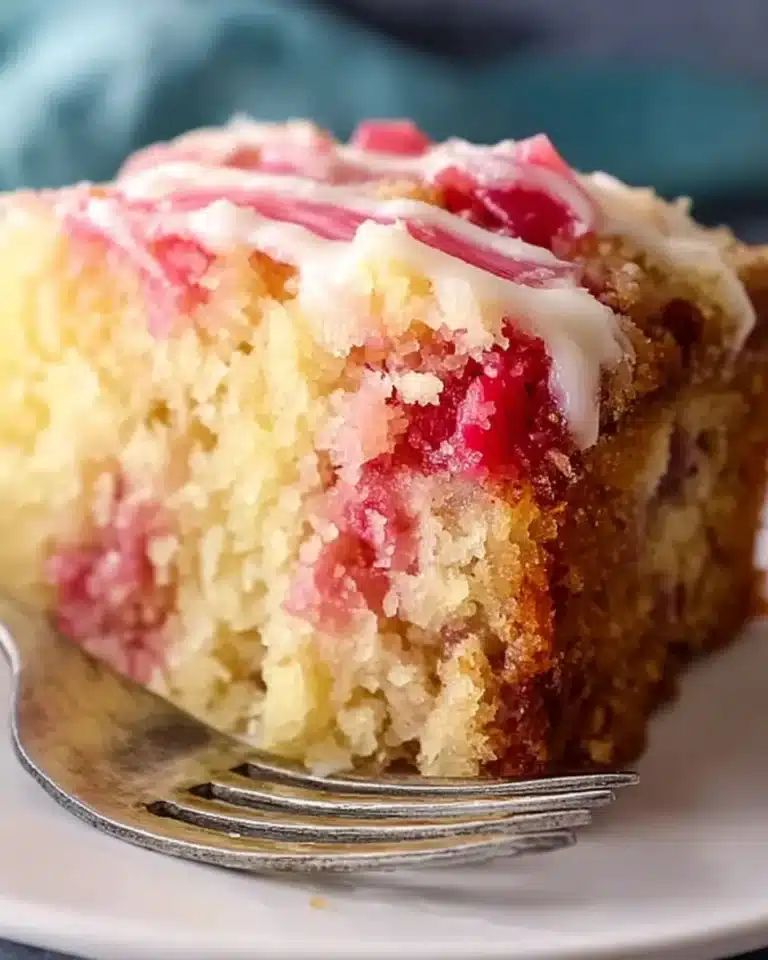Delicious slice of rhubarb cake made with cake mix served on a plate