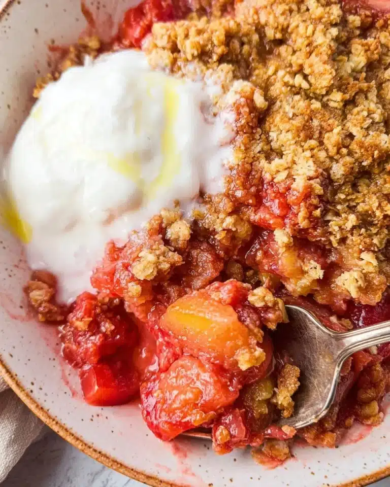 Delicious rhubarb crisp dessert topped with a golden oat crumble.
