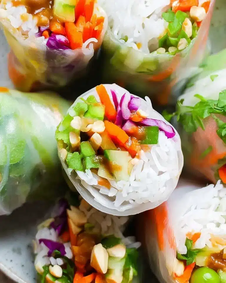 Delicious spring rolls with creamy peanut sauce served on a plate