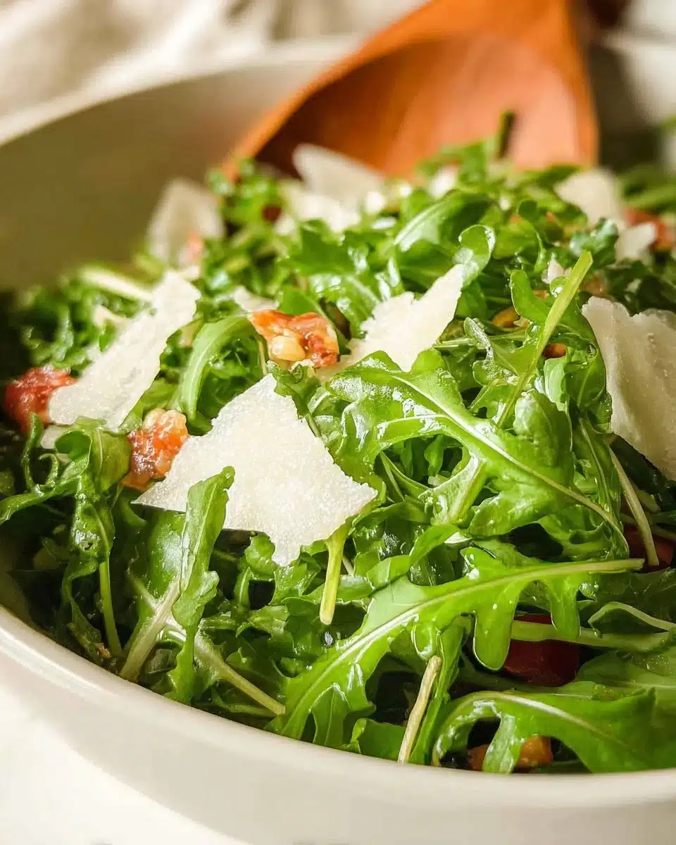 A vibrant arugula salad with cherry tomatoes and feta cheese serving on a plate