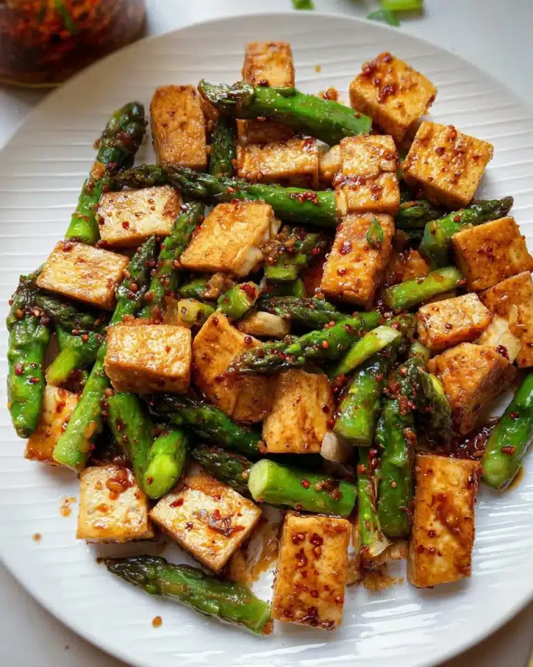 Colorful asparagus tofu stir fry with vegetables in a skillet