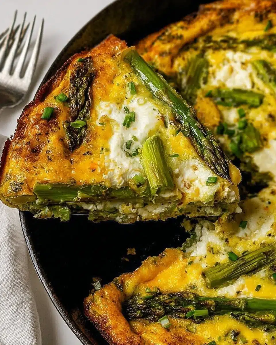 Fresh asparagus frittata served on a plate with herbs