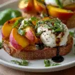Balsamic Peach Burrata Toast topped with fresh peaches and creamy cheese