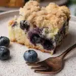 Delicious Blueberry Buckle Coffee Cake topped with fresh blueberries and crumble.