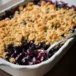 Delicious blueberry crisp served in a bowl with a golden brown topping
