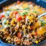 Cheesy Taco Rice Skillet served in a colorful bowl garnished with fresh herbs