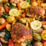 Baked chicken thighs with colorful vegetables on a plate