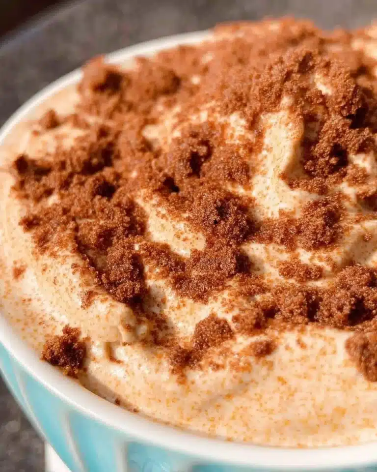 Churro Cheesecake Dip served in a bowl with cinnamon-sugar sprinkle