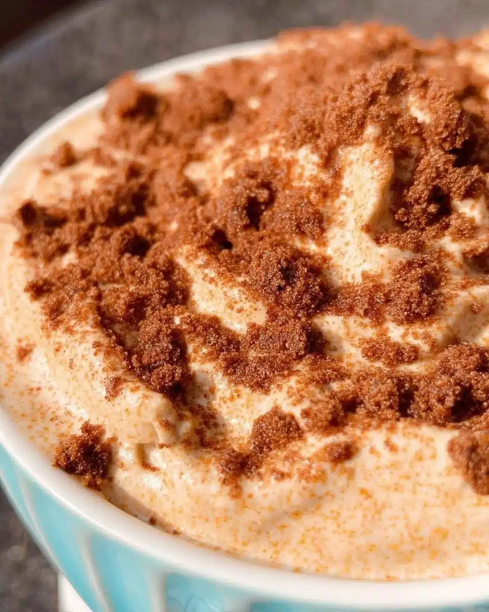 Churro Cheesecake Dip served in a bowl with cinnamon-sugar sprinkle
