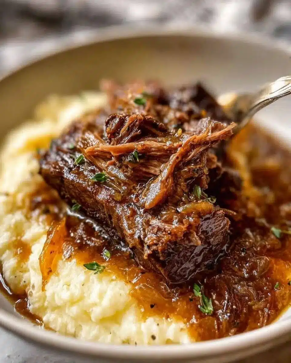 Delicious French onion pot roast served with melted cheese and fresh herbs