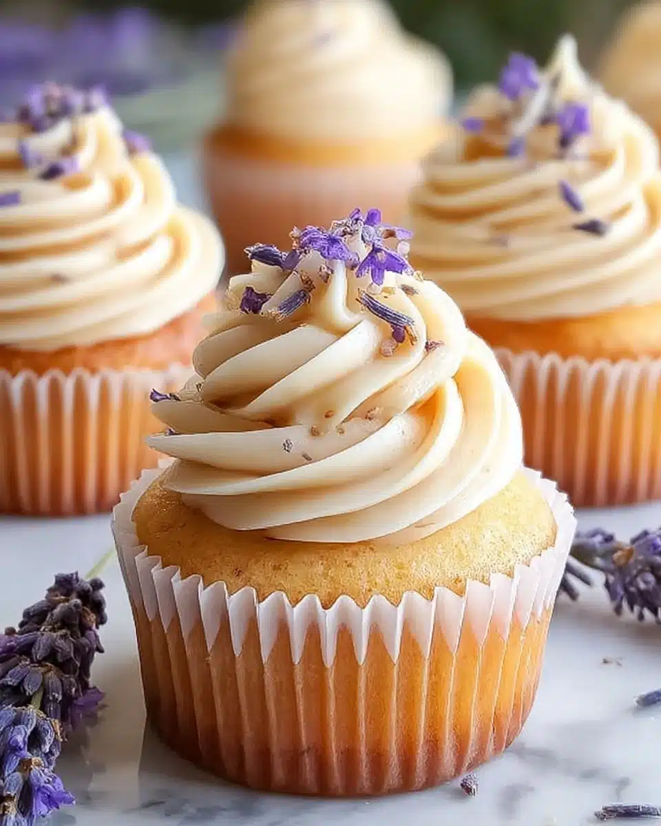 Lavender honey cupcakes topped with creamy frosting and edible flowers