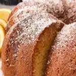 Delicious lemon olive oil cake served on a plate with lemon garnish.