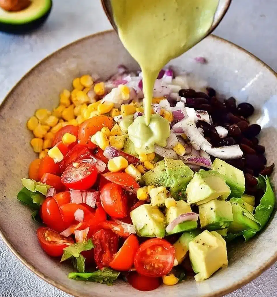 Colorful Mexican avocado salad with tomatoes, corn, and lime dressing