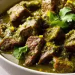 Bowl of Mexican Beef Green Chili topped with fresh cilantro and cheese