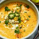 Bowl of delicious Mexican street corn soup topped with cilantro and cheese