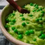 A bowl of creamy mushy peas served as a British side dish