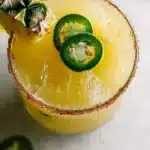 Pineapple Jalapeño Margarita garnished with jalapeño slices and pineapple.