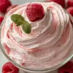 Delicious pink mousse dessert served in a glass with fresh berries