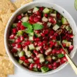 Fresh Pomegranate Salsa served in a bowl with tortilla chips.