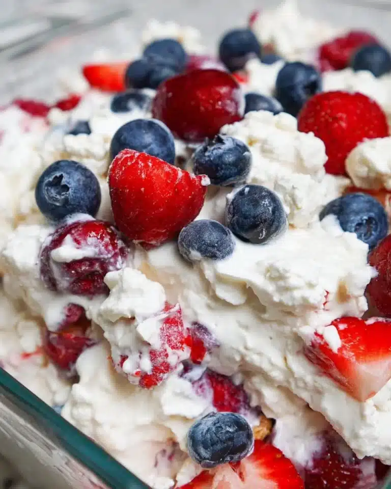 Red, White, and Blue Cheesecake Salad featuring fresh berries and creamy cheesecake