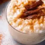 Delicious bowl of creamy rice pudding topped with cinnamon and raisins