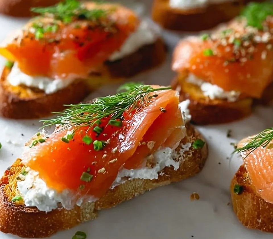 Delicious smoked salmon crostini topped with cream cheese and herbs.