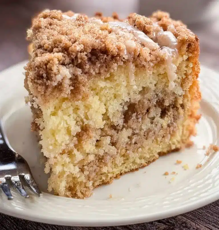 Delicious sour cream coffee cake served on a plate with coffee