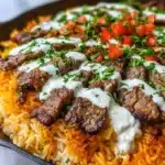 Delicious Steak Queso Rice with tender steak, melted queso, and rice.