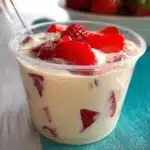 Fresh strawberries topped with creamy whipped cream for a delightful dessert