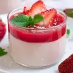 Delicious strawberry panna cotta served with fresh strawberries on top