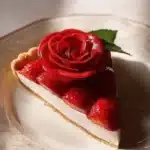 Beautifully arranged strawberry rose tart with fresh strawberries and rose petals.