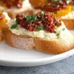 Delicious sun-dried tomato bruschetta appetizer on a rustic wooden table