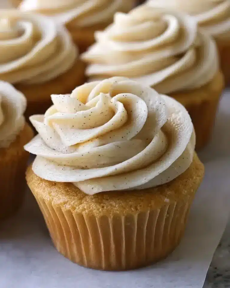 Vanilla brown butter cupcakes with creamy frosting on a white plate