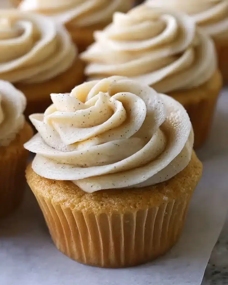 Vanilla brown butter cupcakes with creamy frosting on a white plate