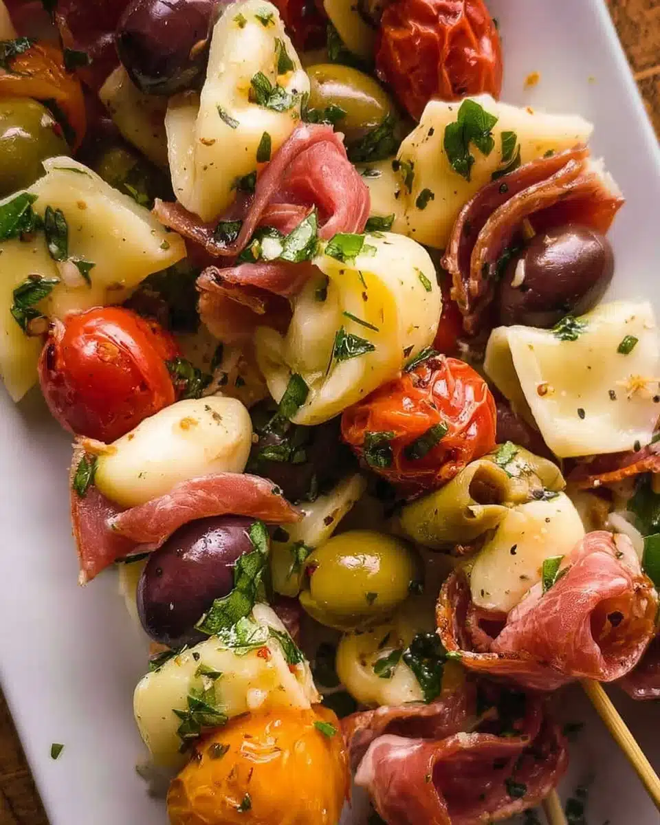 Colorful antipasto skewers with olives, cheese, and vegetables on a wooden platter