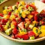 Bowl of Avocado Strawberry Mango Salsa with fresh ingredients