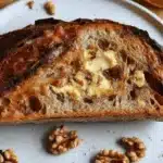 Freshly baked honey walnut sourdough bread loaf with a golden crust