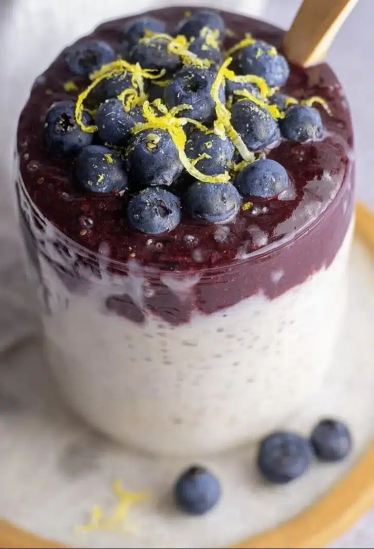 Lemon Blueberry Chia Pudding in a glass topped with fresh blueberries and lemon slices