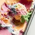 Colorful scoop of Rainbow Sherbet in a bowl with a spoon