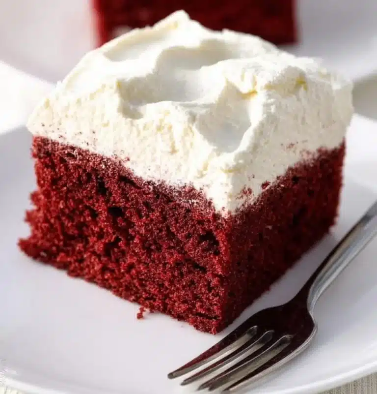 Delicious slice of homemade Red Velvet Cake with cream cheese frosting